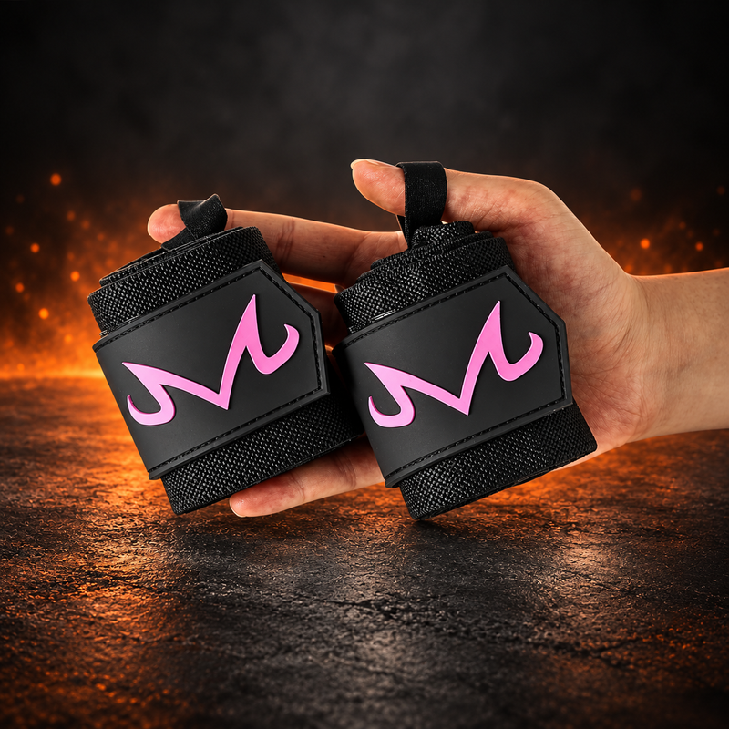 Rolled pair of M Pink wrist wraps held in one hand, black wraps with a curled hot pink M on each end tab