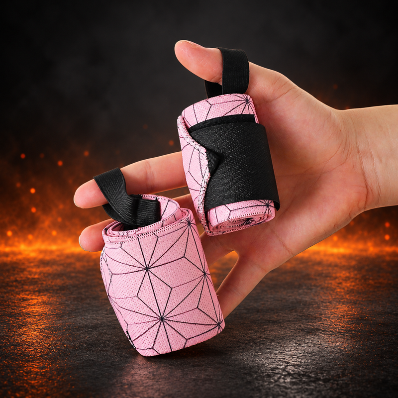 Rolled pair of Edo wrist wraps in the Asanoha style, pale pink with a dark hemp-leaf pattern and black thumb loops