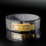 Gray leather weightlifting belt. Gold lever on powerlifting belt