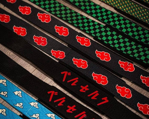 Patterned lifting straps arranged diagonally on a wooden surface.