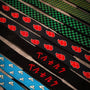 Patterned lifting straps arranged diagonally on a wooden surface.