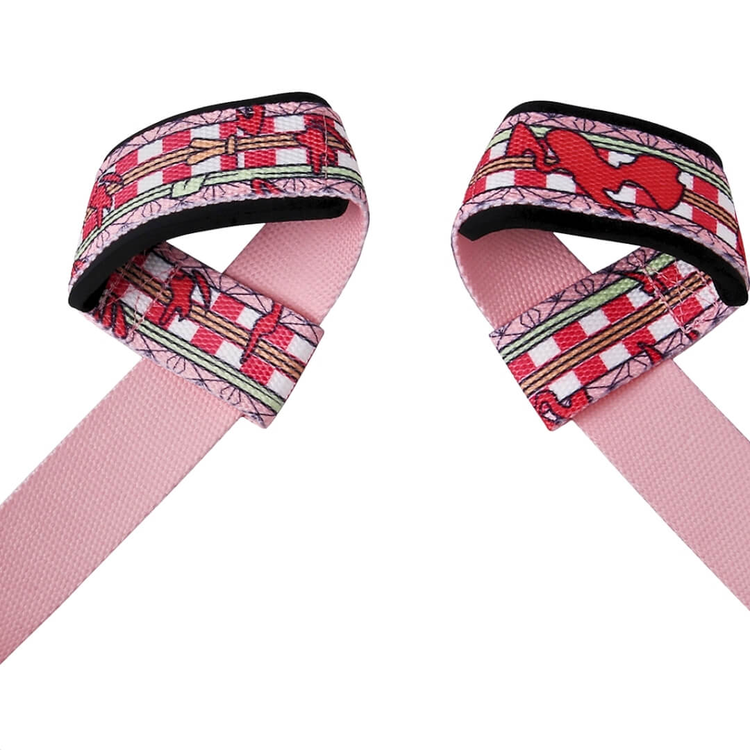 Close-up of the loops on the Kurenai lifting straps for deadlifts, crimson print and hemp-leaf edges over a pink reverse