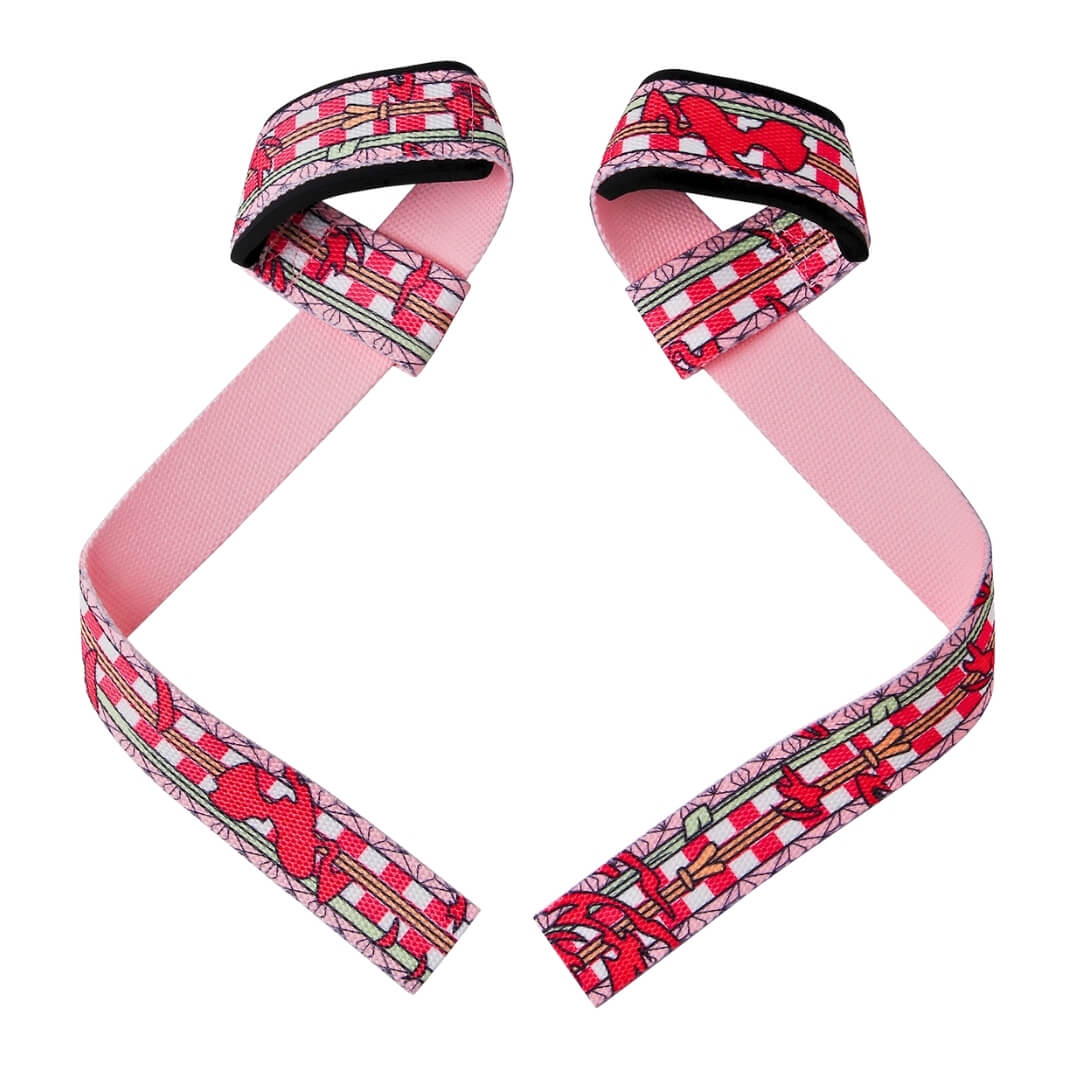 Pair of Kurenai deadlift straps laid out, crimson kimono print on the loops and tails with a plain pink reverse
