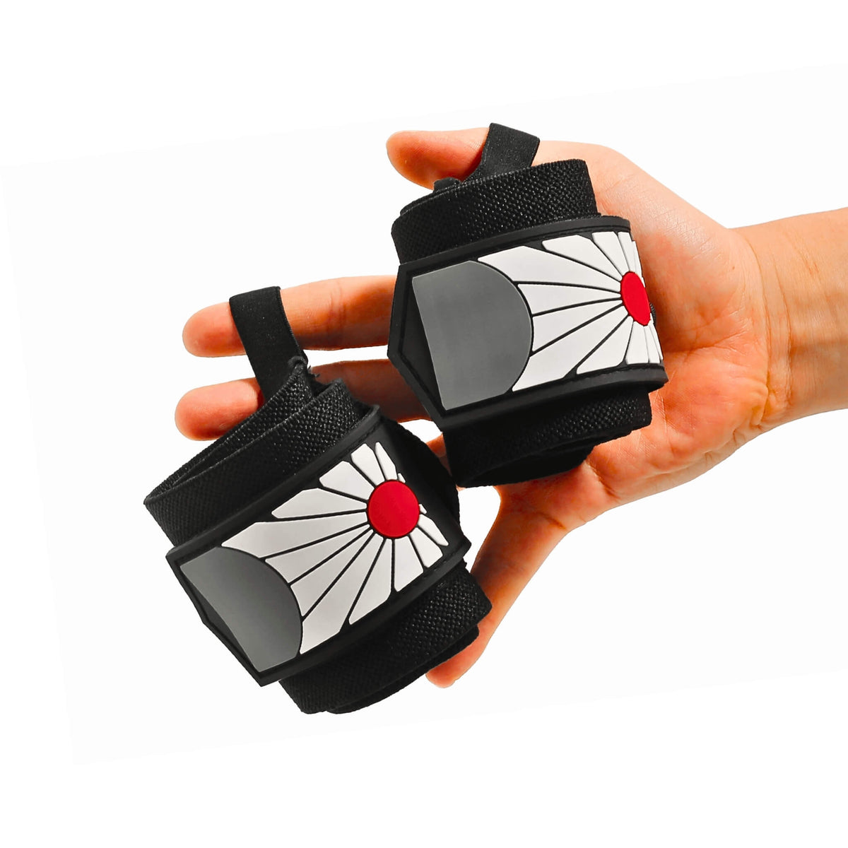 Pair of Edo wrist wraps held in the hand, Hanafuda style with a white sunburst and red circle on black