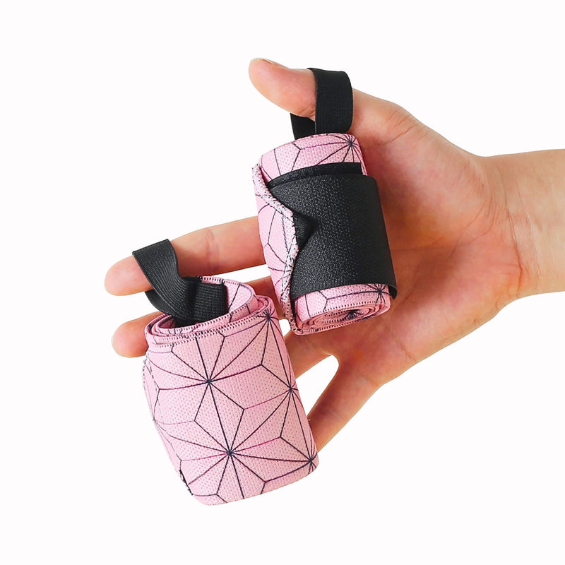 Rolled pair of Edo wrist wraps in the Asanoha style, pale pink with a dark hemp-leaf pattern and black thumb loops