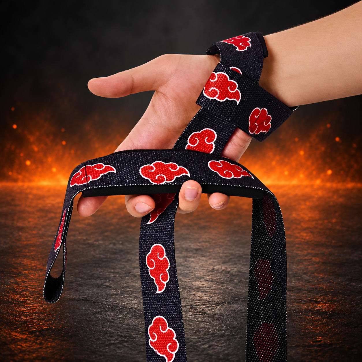 Side view of the Dawn weightlifting straps worn on the wrist, black webbing printed with red clouds outlined in white