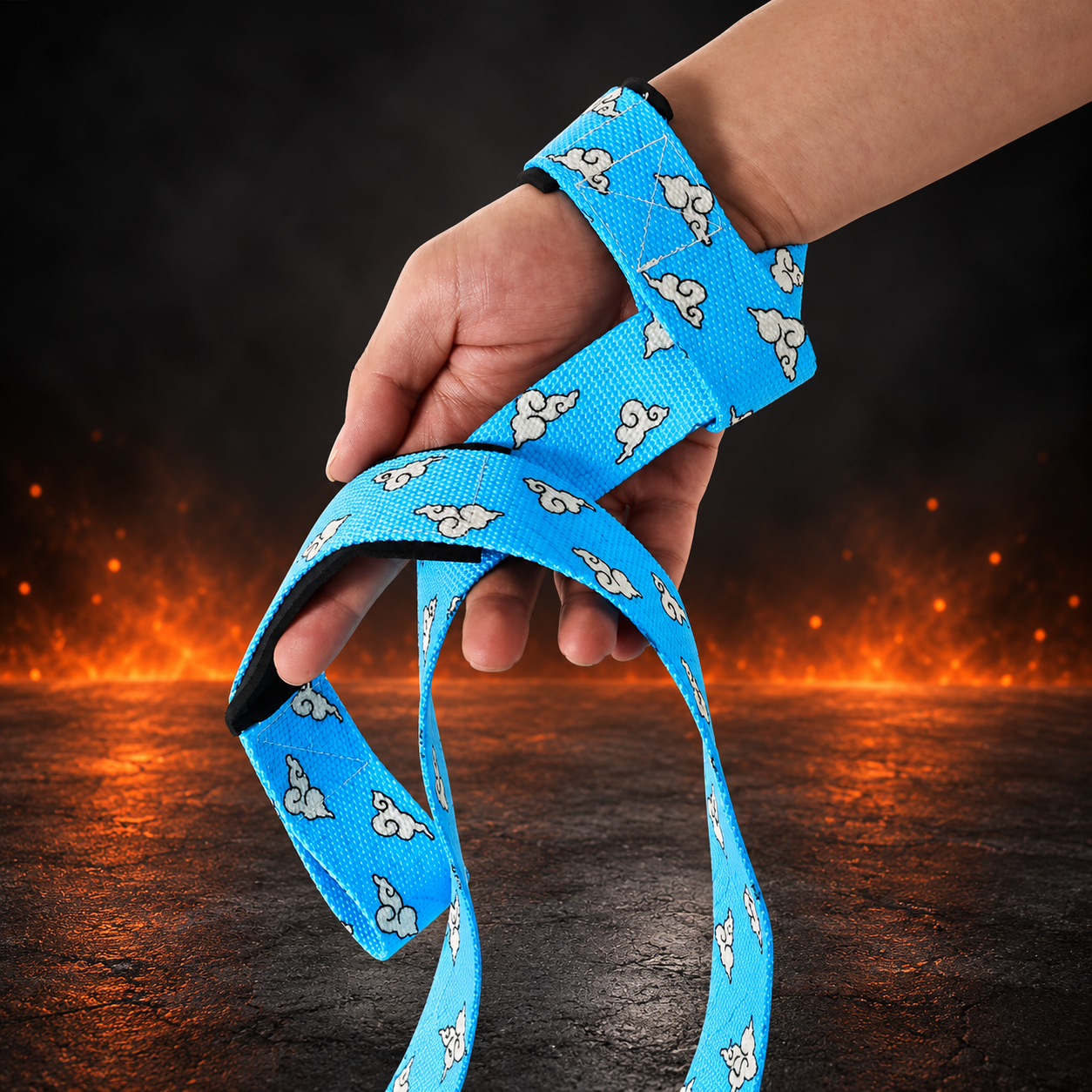 Kumo lifting straps looped on a wrist and wrapped over the hand, sky-blue webbing printed with white curly clouds