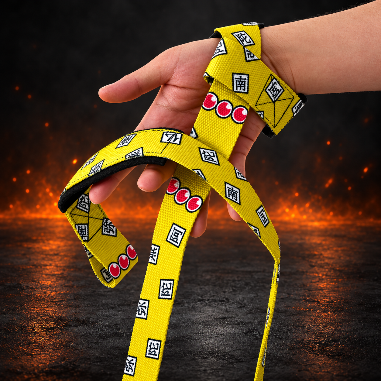 Ofuda lifting straps looped around the hand, bright yellow webbing with black kanji on white tiles and rows of red beads