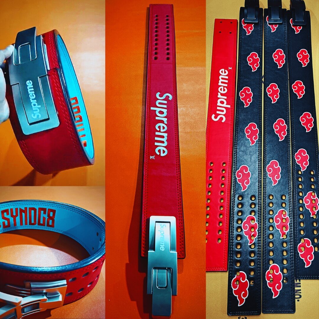 Custom powerlifting lever belts from past orders, red with a white logo print and black with red clouds.