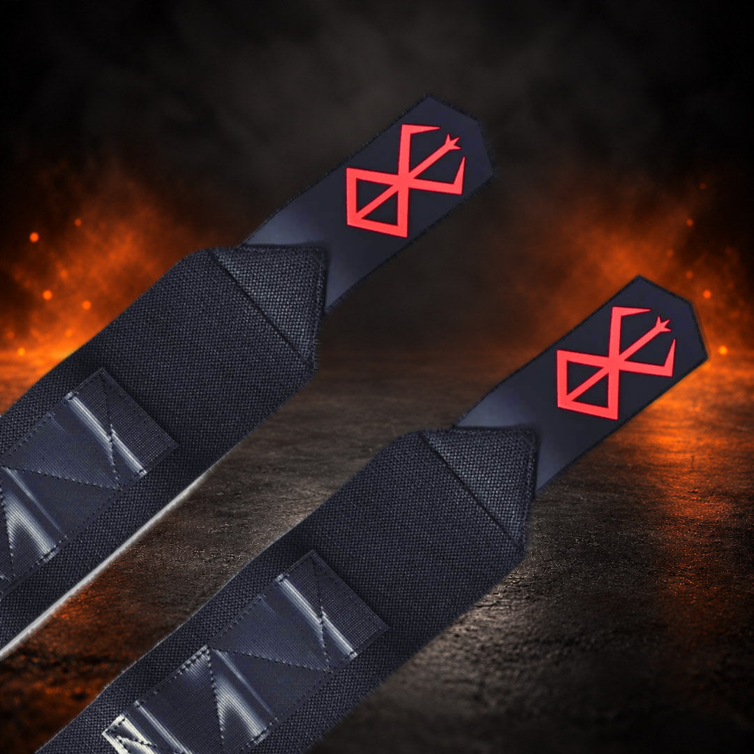 Powerlifting wrist wraps with a red sigil on each pointed black end tab, close-up.