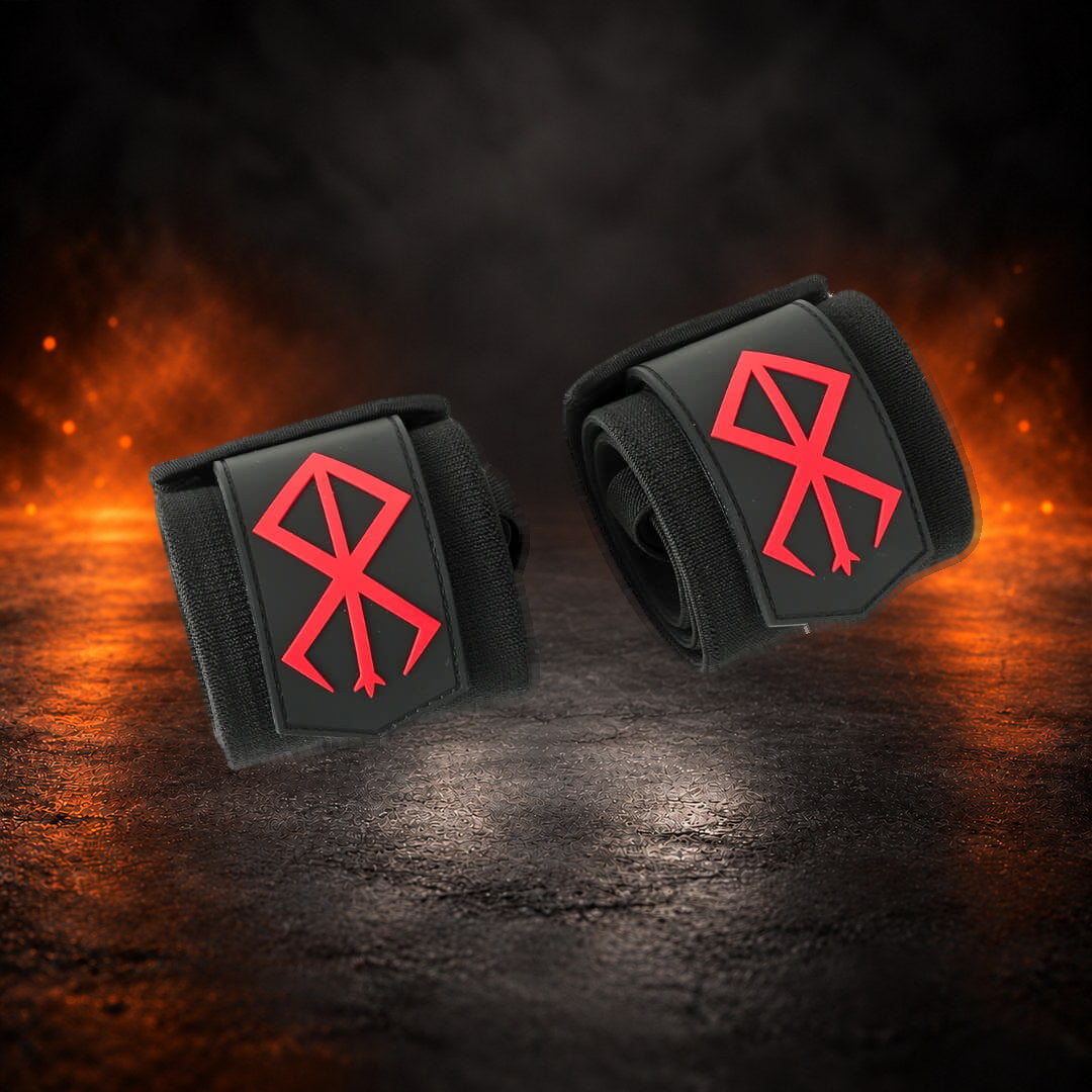 Powerlifting wrist wraps, rolled black pair with a red sigil on each tab, angled view.