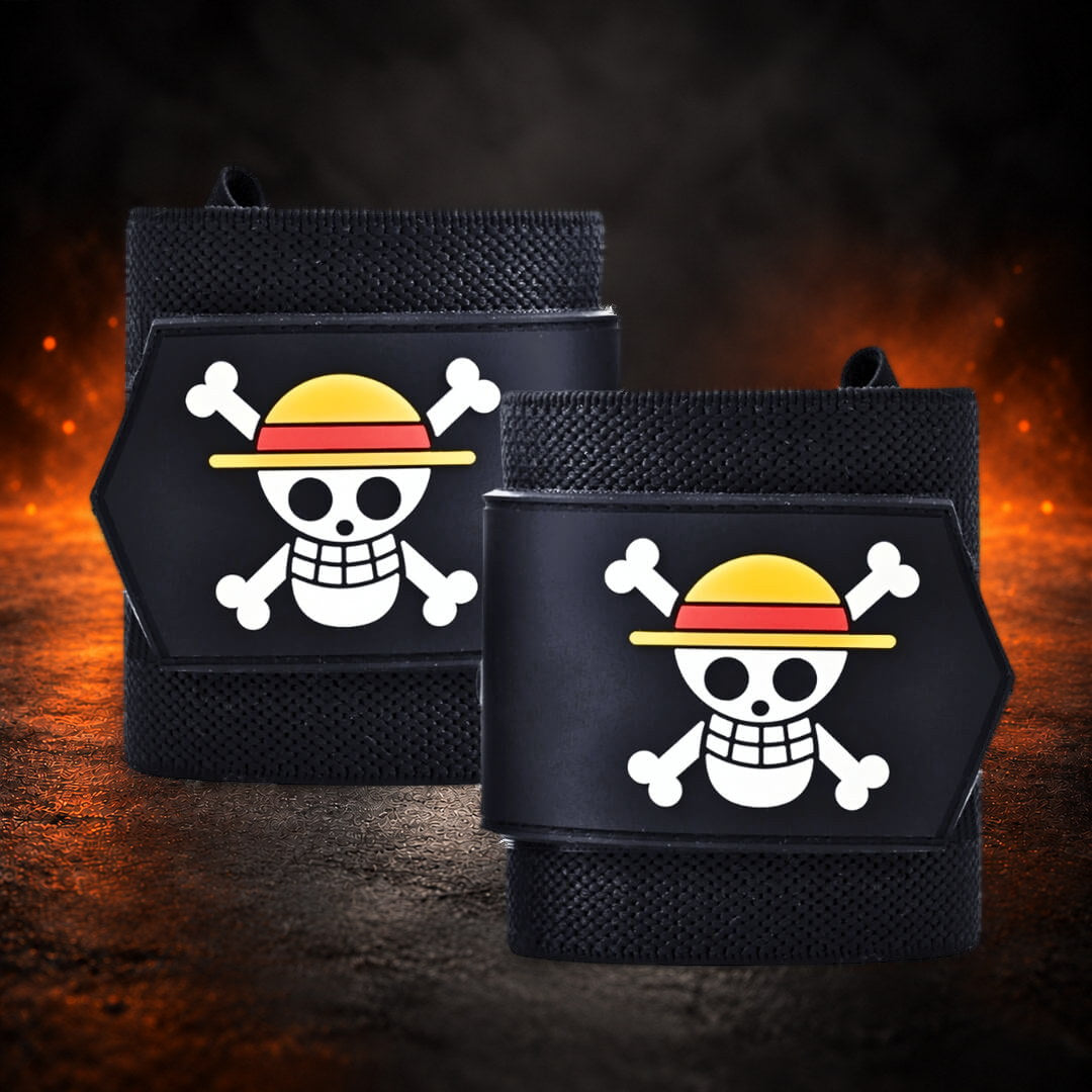 Powerlifting wrist wraps, rolled black pair with raised skull and crossbones patches, front view.