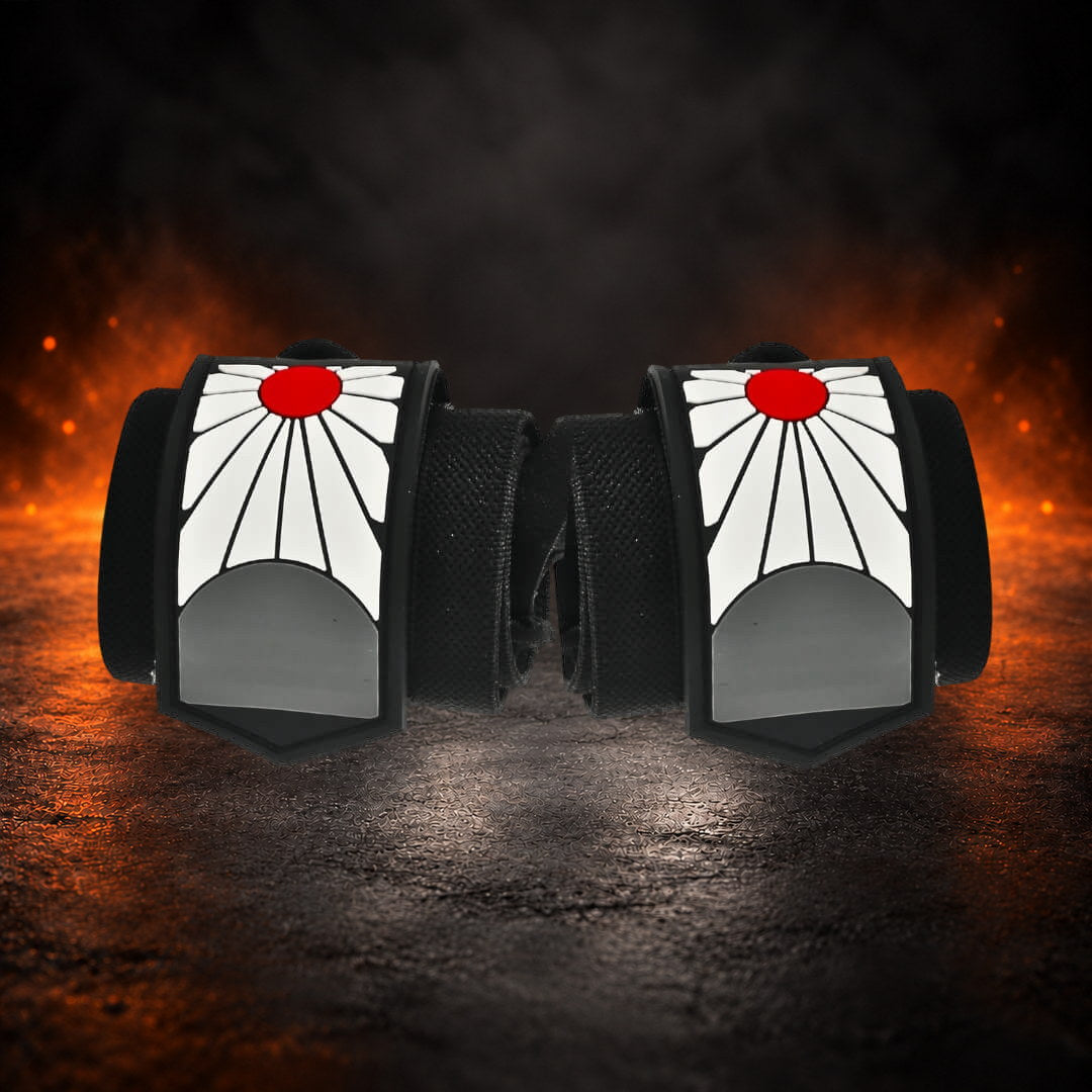 Powerlifting wrist wraps, rolled black pair side by side with red sun panels facing forward.