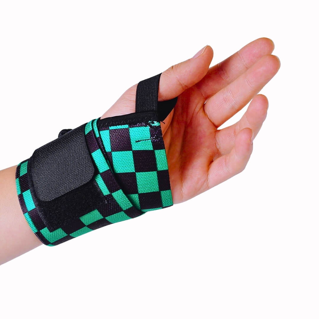 Powerlifting wrist wraps in green and black checkerboard, fastened on the wrist, thumb loop on.