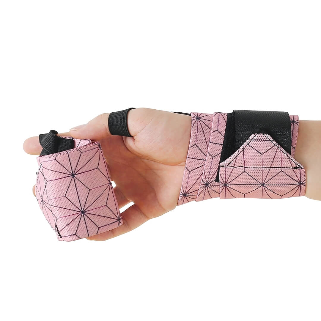 Powerlifting wrist wraps in pink hemp-leaf print, one on the wrist and one rolled in the palm.