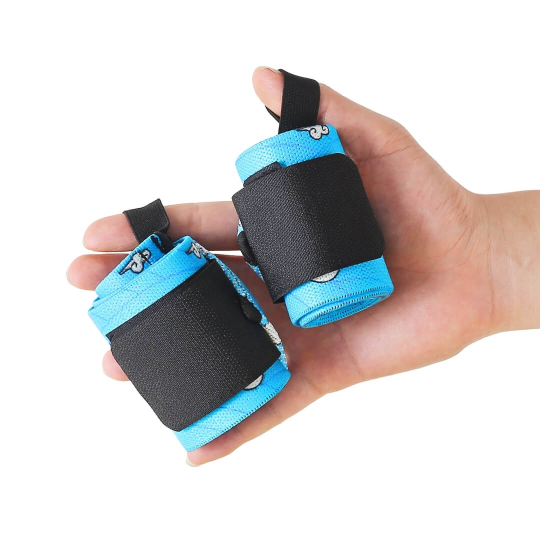 Powerlifting wrist wraps in sky blue with white clouds and black closures, rolled pair in hand.