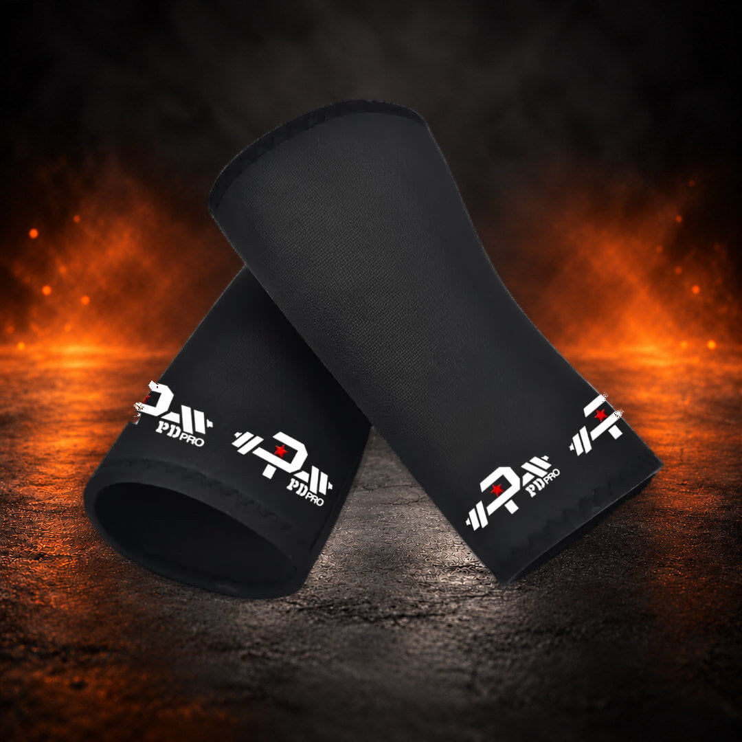 7mm stiff knee sleeves in black with white barbell logos, one leaning across the other.