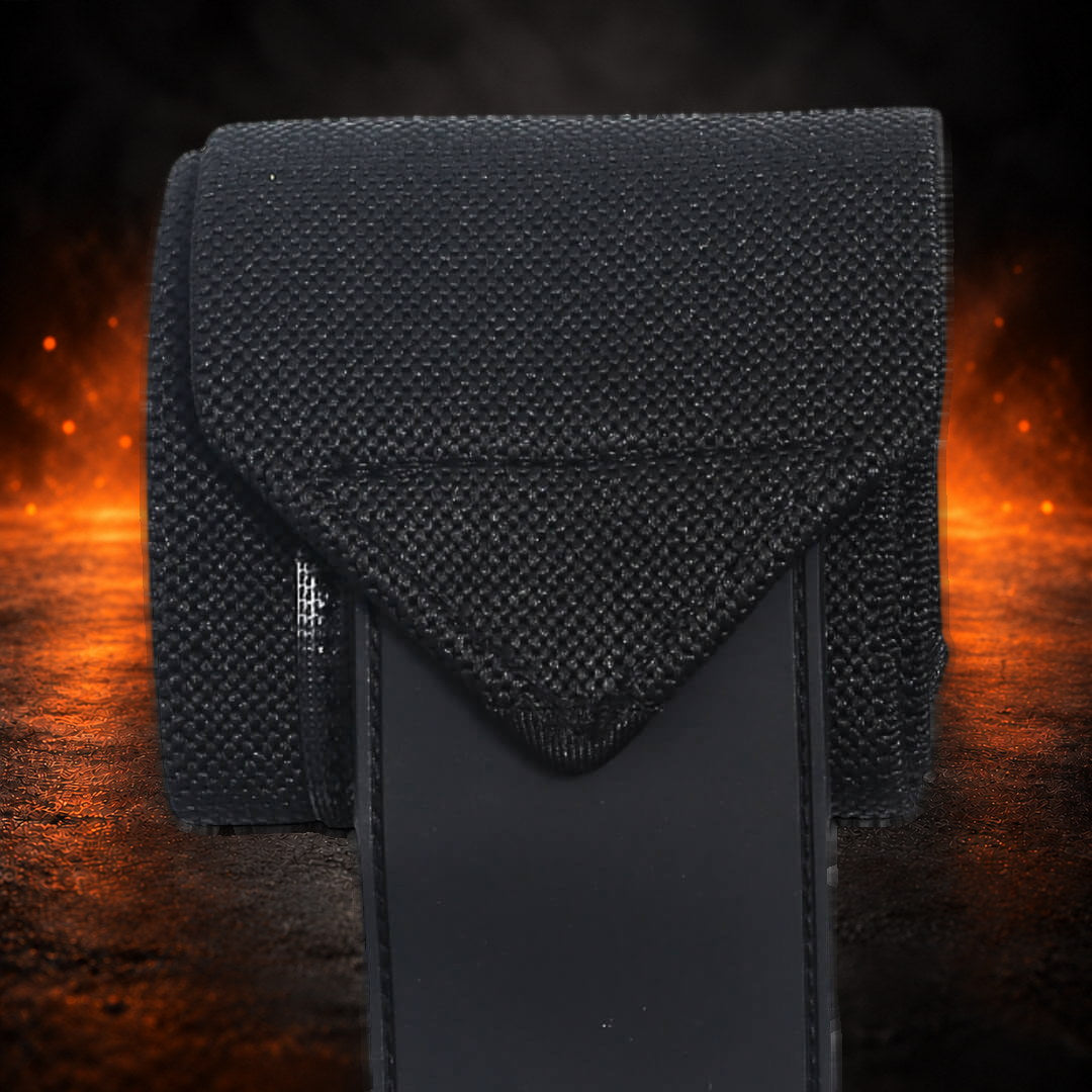Powerlifting wrist wraps, black woven elastic folded to a point over the black closure panel, close-up.