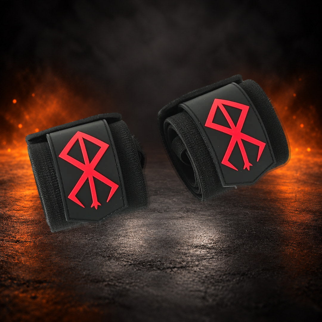 Stiff powerlifting wrist wraps, rolled black pair with a red sigil on each tab, angled view.
