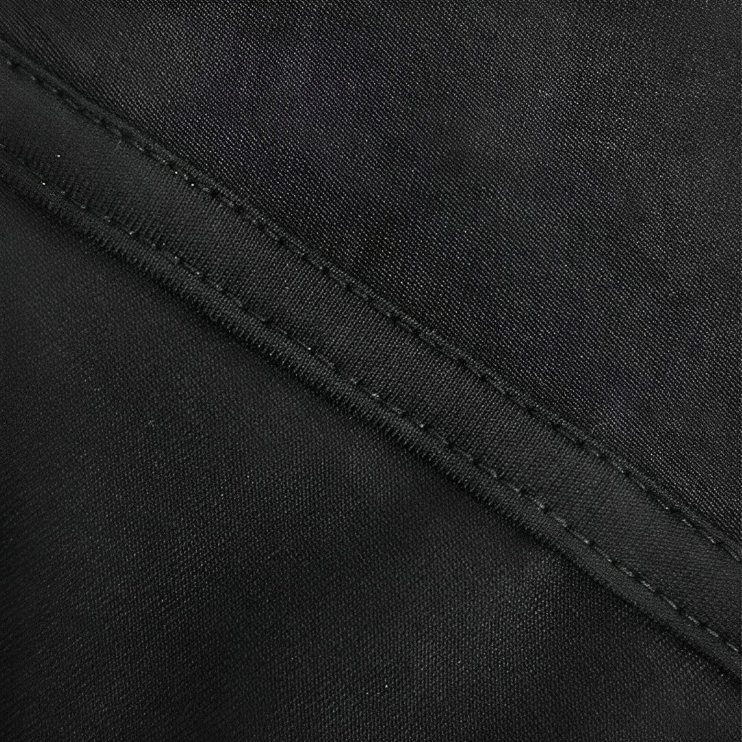 Bar grip shirt fabric close-up, black knit with a stitched seam.