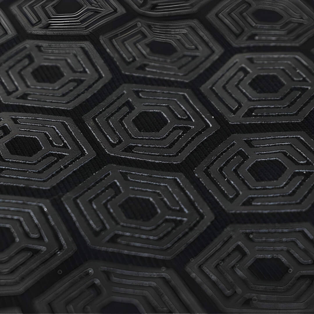 Bar grip shirt hex grip panel, raised black hexagons with ridged inner lines, macro close-up.