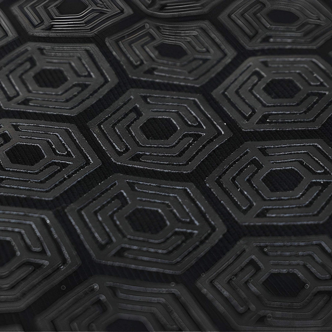 Bar grip shirt hex grip panel, raised black hexagons with ridged inner lines, macro close-up.