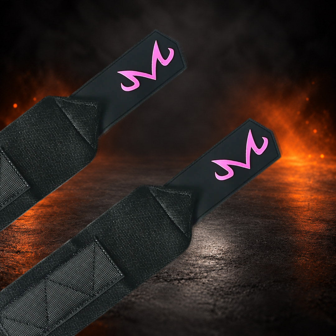 Stiff powerlifting wrist wraps with a curled pink M on each pointed black end tab, close-up.