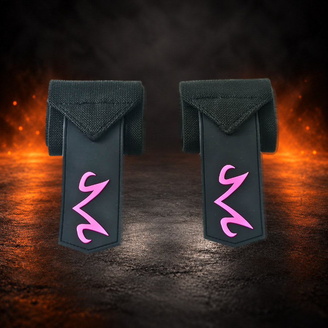 Stiff powerlifting wrist wraps, rolled black pair with pink M end tabs hanging down.