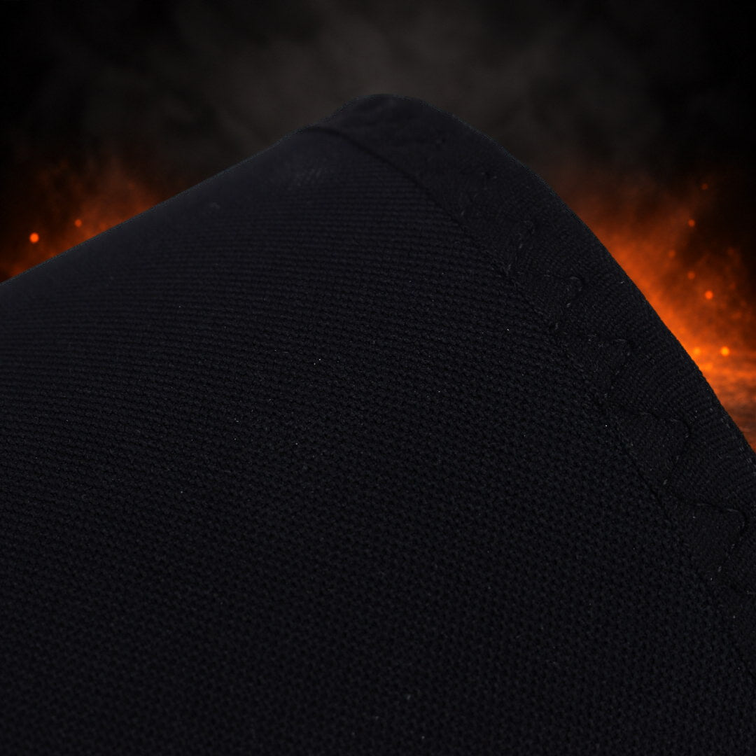 7mm stiff knee sleeves in black, close-up of the plain fabric and stitched edge at the opening.