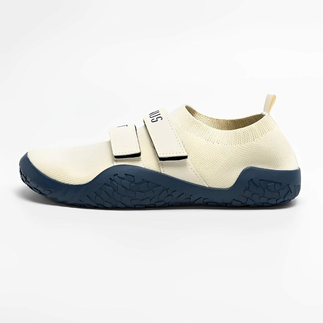 Deadlift slippers in cream with matching straps and a deep blue sole, side view.