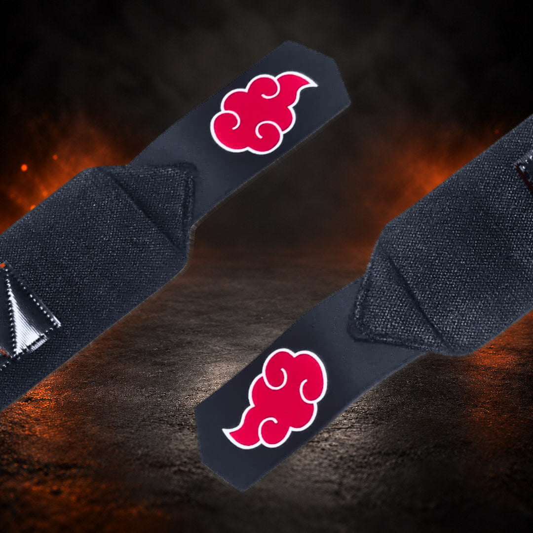 Powerlifting wrist wraps with white-edged red clouds on the pointed tail tabs, close-up.