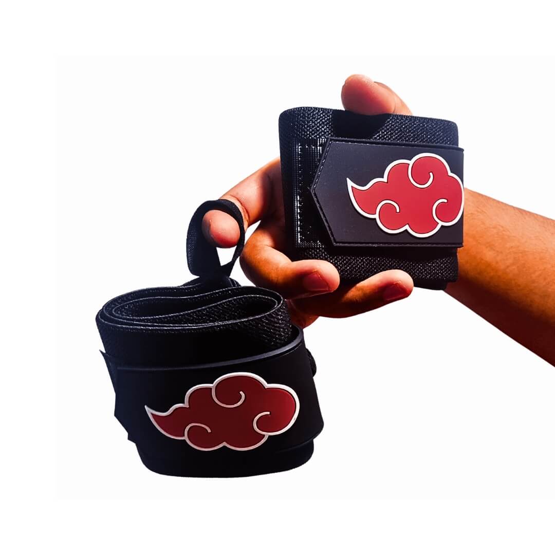 Powerlifting wrist wraps with red cloud patches, one held in hand and one hanging by its loop.