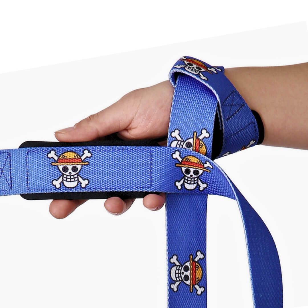 Lifting straps in royal blue skull print, padded section held in the hand.
