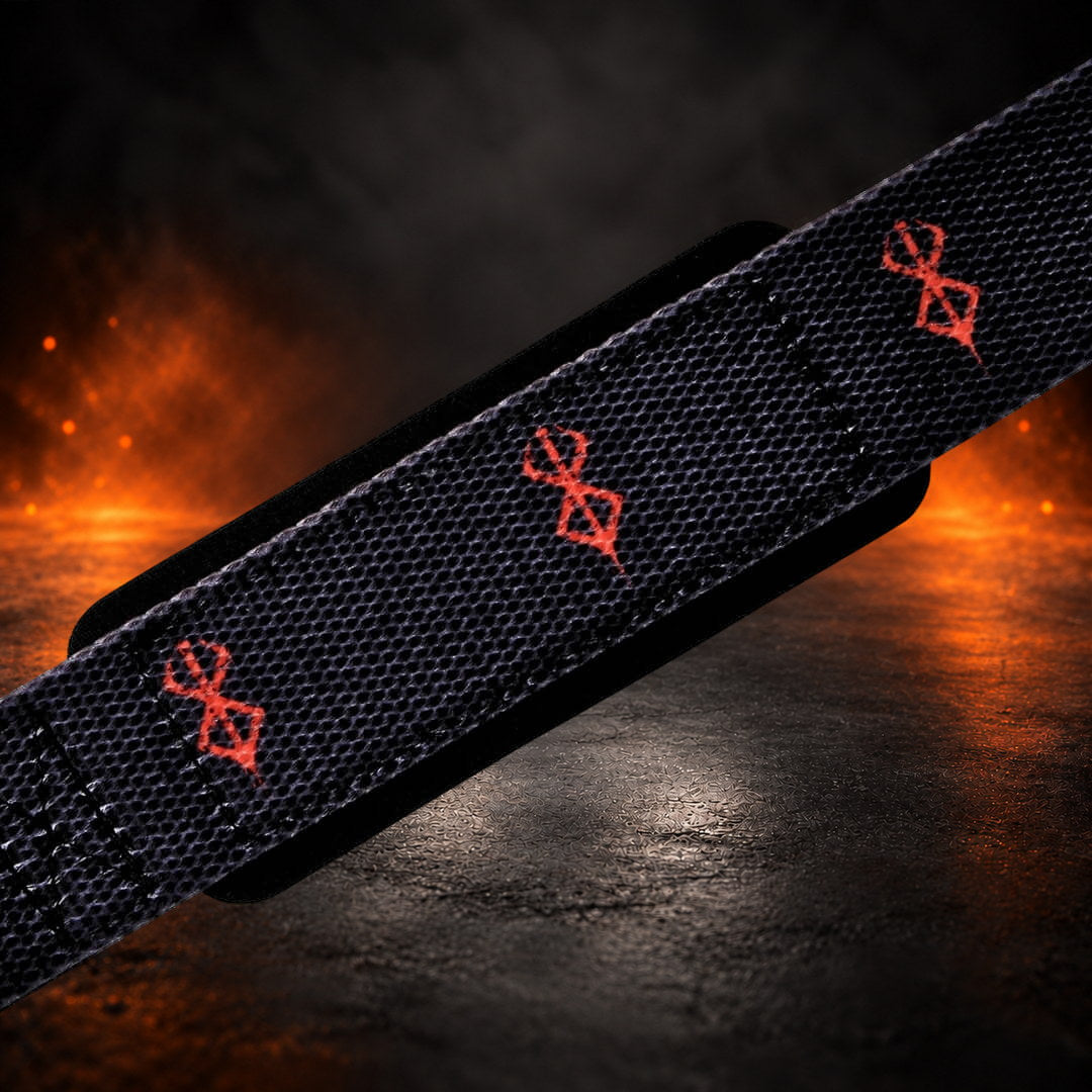 Lifting straps in black, close-up of red sigils on the wrist section over black padding.