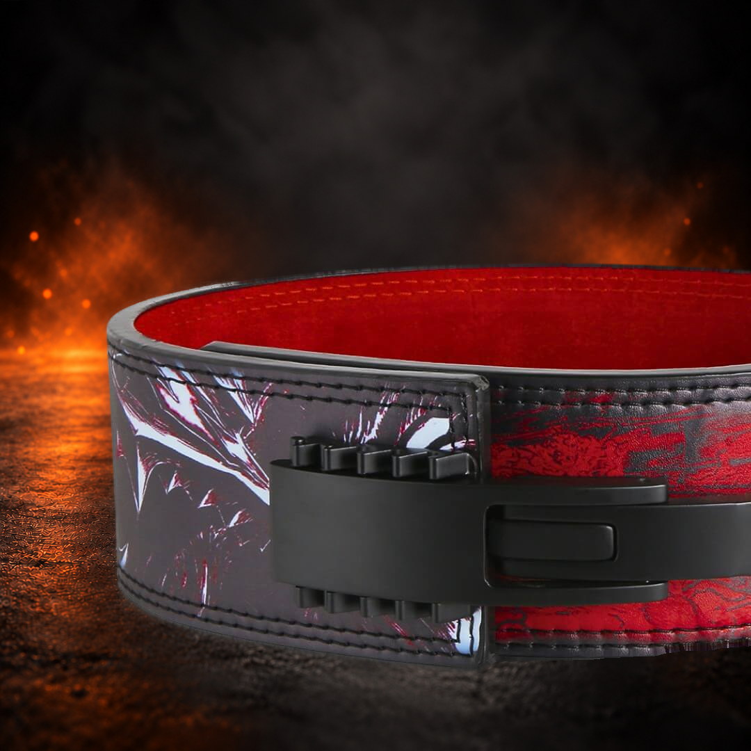 Adjustable lever belt buckle in black over jagged white, red and black smoke print, close-up.