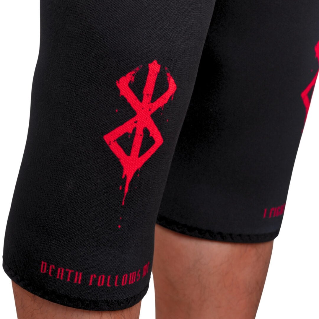 7mm stiff knee sleeves in black with red marks and hem lettering, close-up on an athlete's legs.