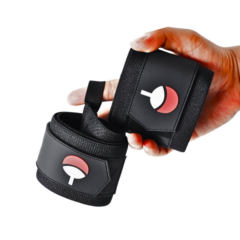 Hand holding the Crimson Fan wrist wraps, a black pair with a raised red-over-white fan crest on each panel